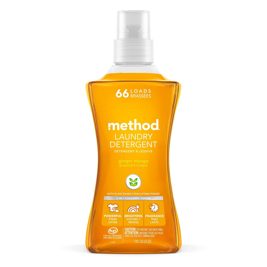 Front-facing Method ginger mango laundry detergent bottle with orange liquid and pump cap on white background.