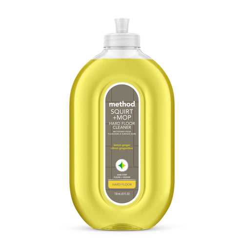 Clear oval bottle of Method Squirt + Mop hard floor cleaner with yellow lemon-ginger liquid and front label