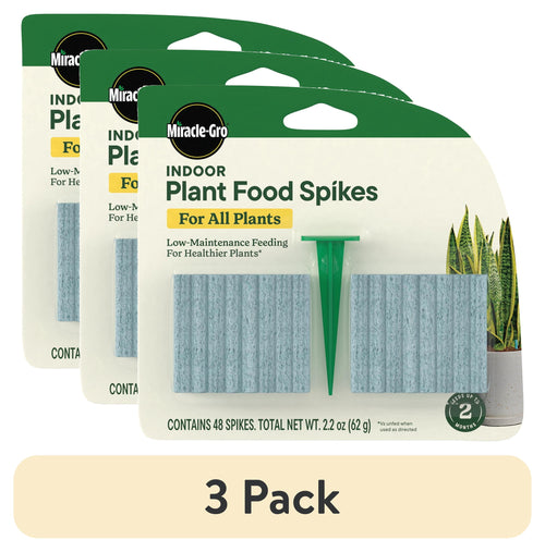 Three overlapping Miracle-Gro Indoor Plant Food Spikes blister packs showing spikes and green insertion stake on white backing
