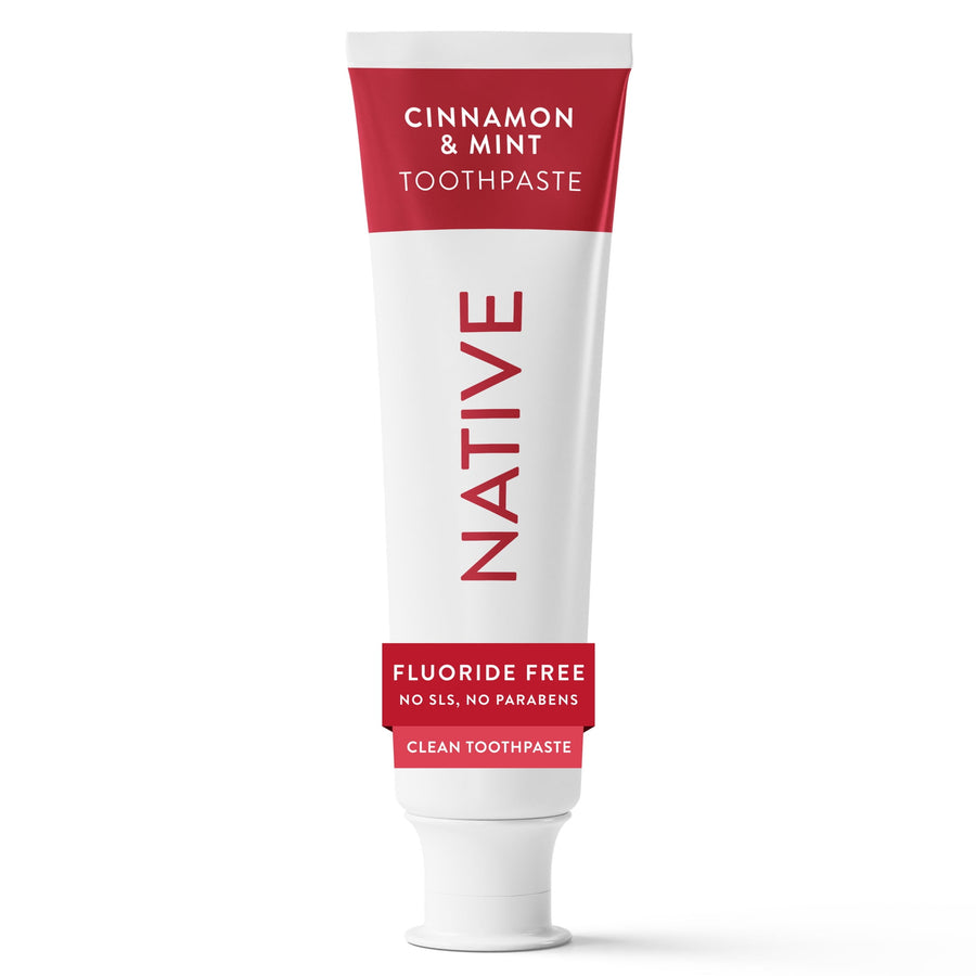 White tube of Native cinnamon & mint toothpaste with red label standing upright on white background