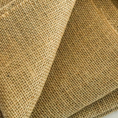 Close-up of natural burlap fabric showing coarse woven texture and fibers