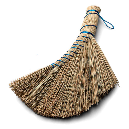 Natural straw whisk broom with blue binding and hanging loop photographed on white background.