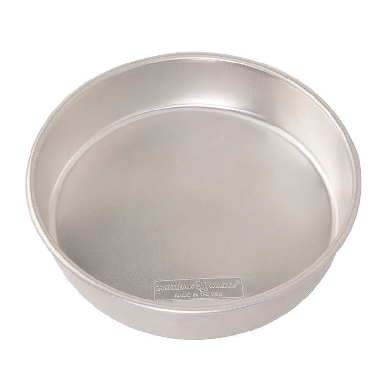 Nordic Ware silver aluminum 10-inch round cake pan shown at a slight angle, interior visible