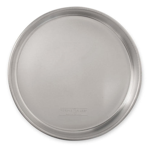 Nordic Ware aluminum 12-inch round layer cake pan with rolled rim and embossed brand mark, top-down view