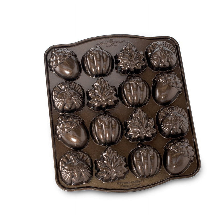 Nordic Ware nonstick metal cakelet pan with 16 autumn-shaped cavities in leaf, pumpkin and acorn designs