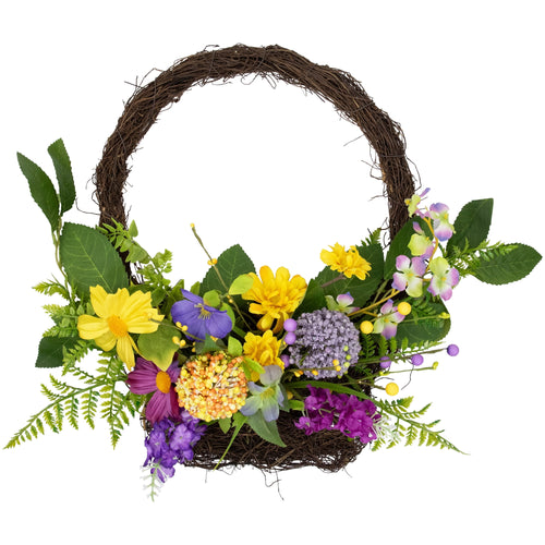 Round twig hanging basket filled with mixed yellow, purple and green artificial wildflowers and foliage on white background