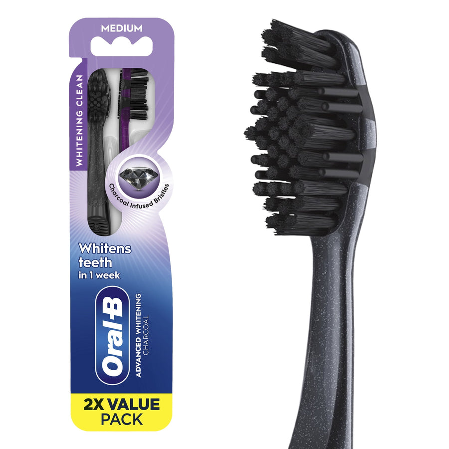 Oral‑B two‑pack charcoal advanced whitening toothbrush package with close-up of black toothbrush head on white background.