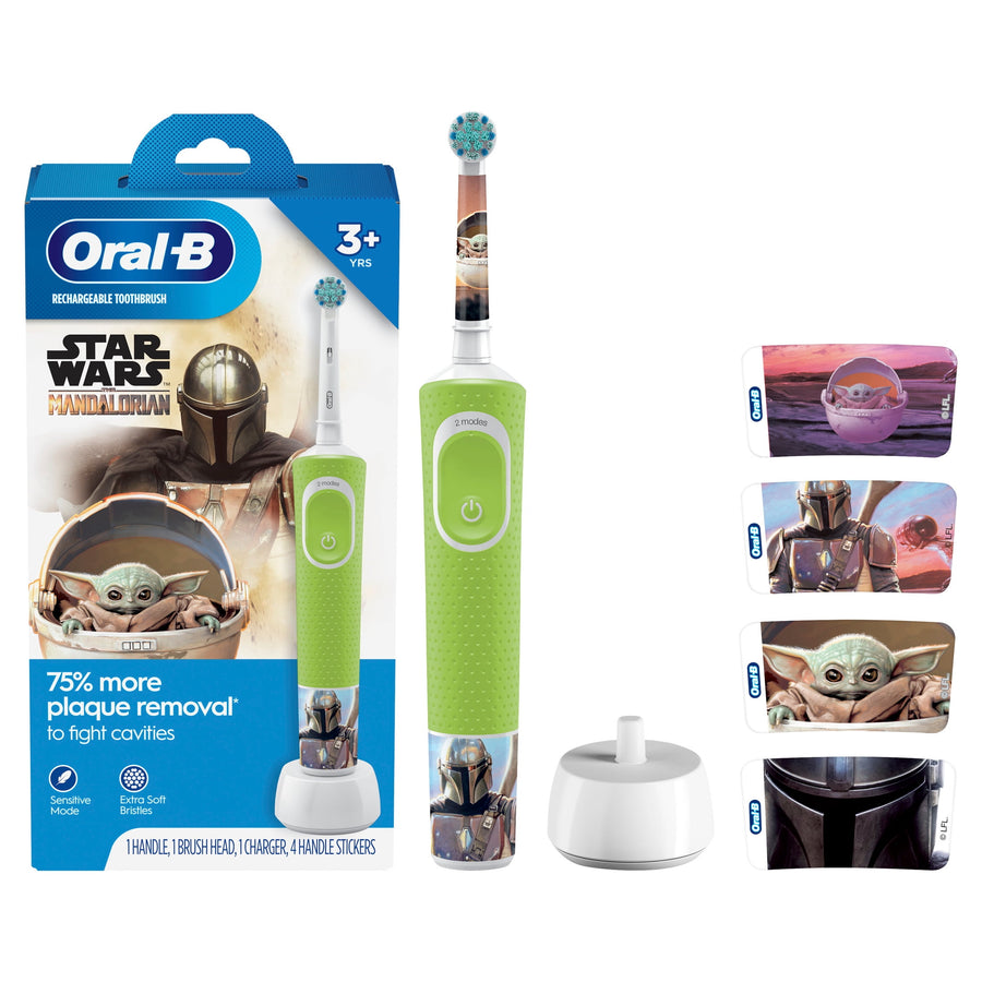 Oral‑B kids electric toothbrush with green handle, charger base and Mandalorian/Baby Yoda packaging and sticker set