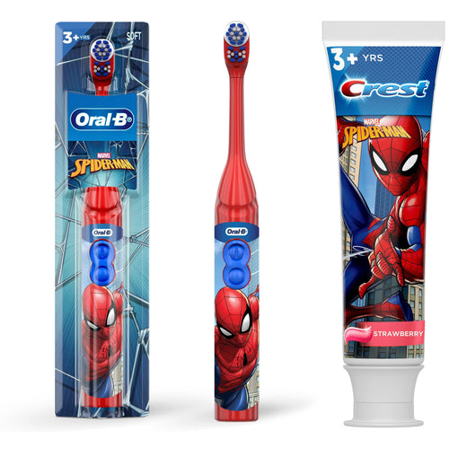 Packaged Oral‑B Spider‑Man battery children's toothbrush, a loose matching toothbrush, and Crest Spider‑Man strawberry toothpaste tube on white background.
