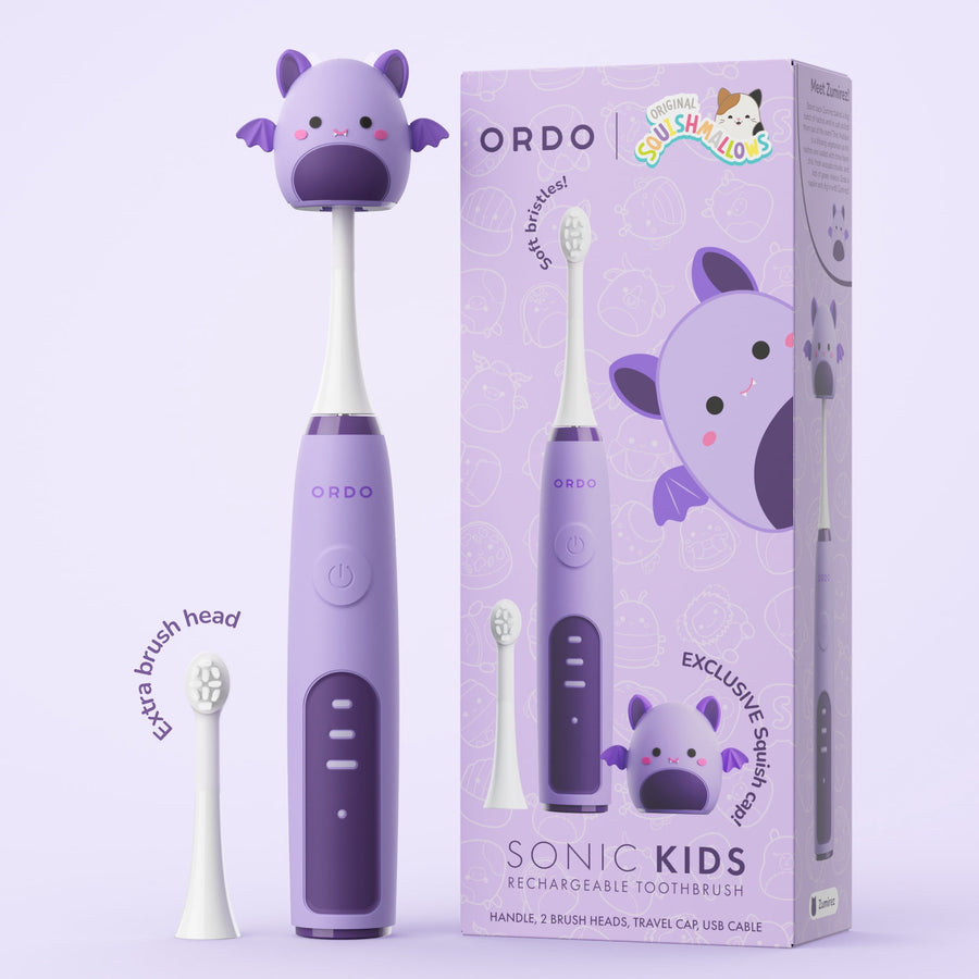 Purple Ordo sonic kids rechargeable toothbrush with Squishmallows-themed packaging and extra brush head shown