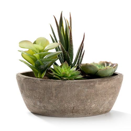 Oval weathered-gray planter filled with a mixed faux succulent arrangement on white background
