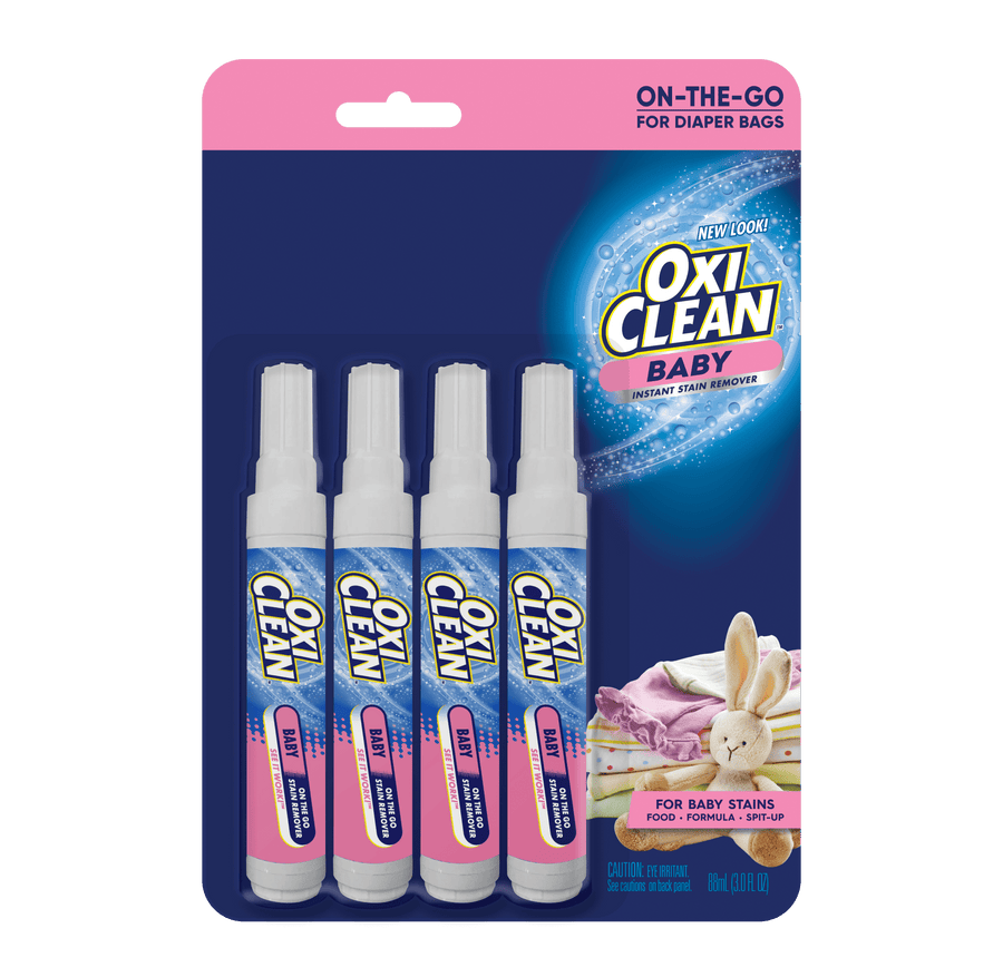 Blister pack of four OxiClean Baby on-the-go stain remover pens displayed on branded blue and pink card with product logo.