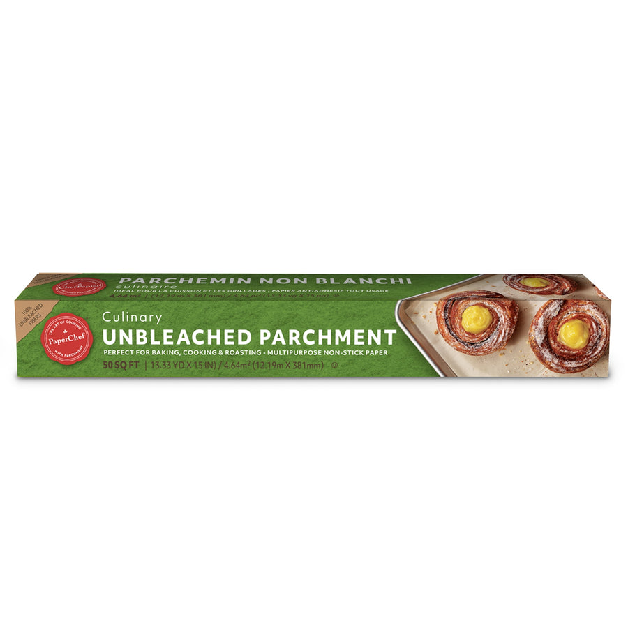 PaperChef unbleached parchment roll in its green branded box with a baking sheet of pastries pictured