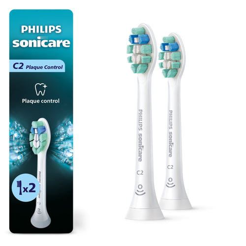 Two white Philips Sonicare C2 plaque control replacement brush heads beside product packaging on white background