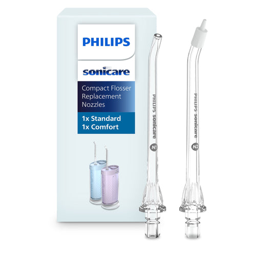 Two clear Philips Sonicare compact flosser replacement nozzles displayed next to product packaging with brand logo.
