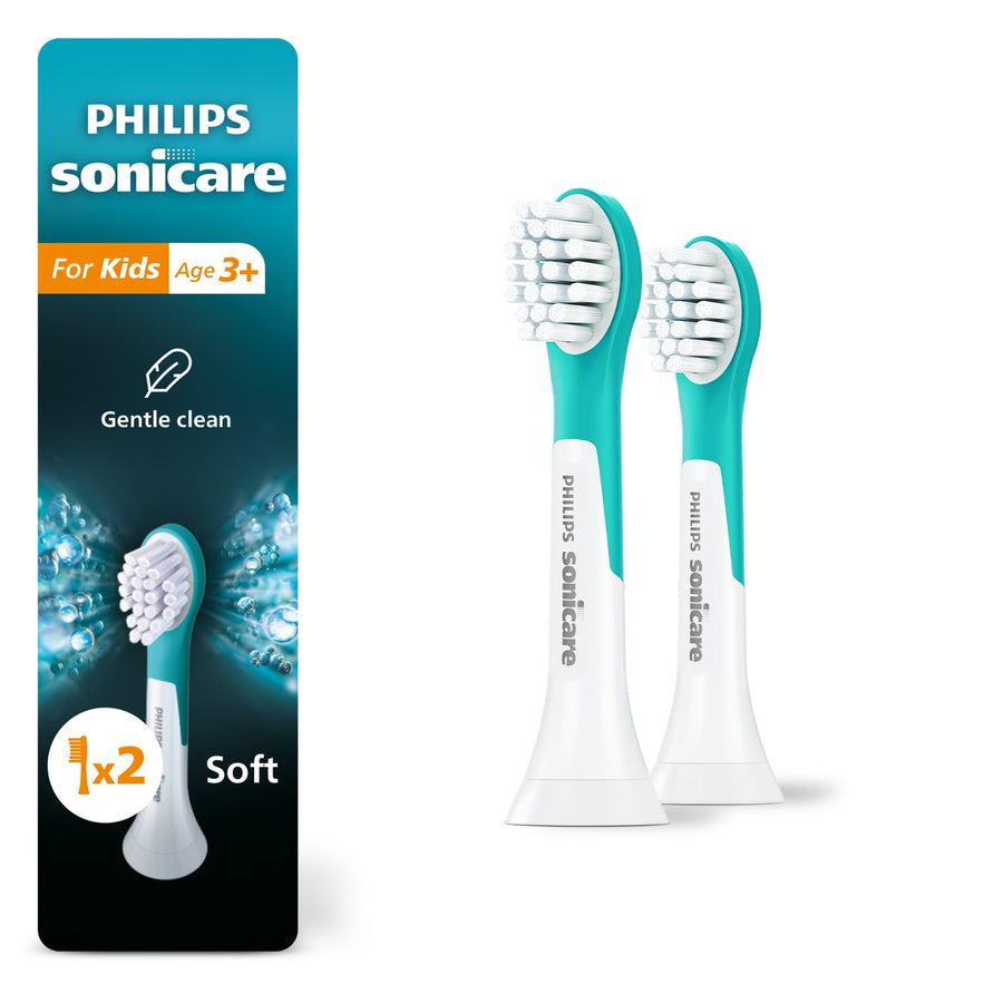 Two turquoise-and-white Philips Sonicare kids replacement brush heads shown next to product packaging panel on white background