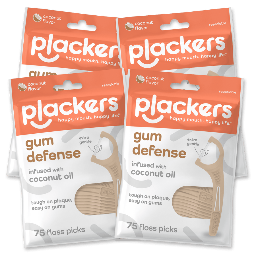 Four resealable Plackers Gum Defense pouches showing coconut-flavored floss pick packaging and product illustration.