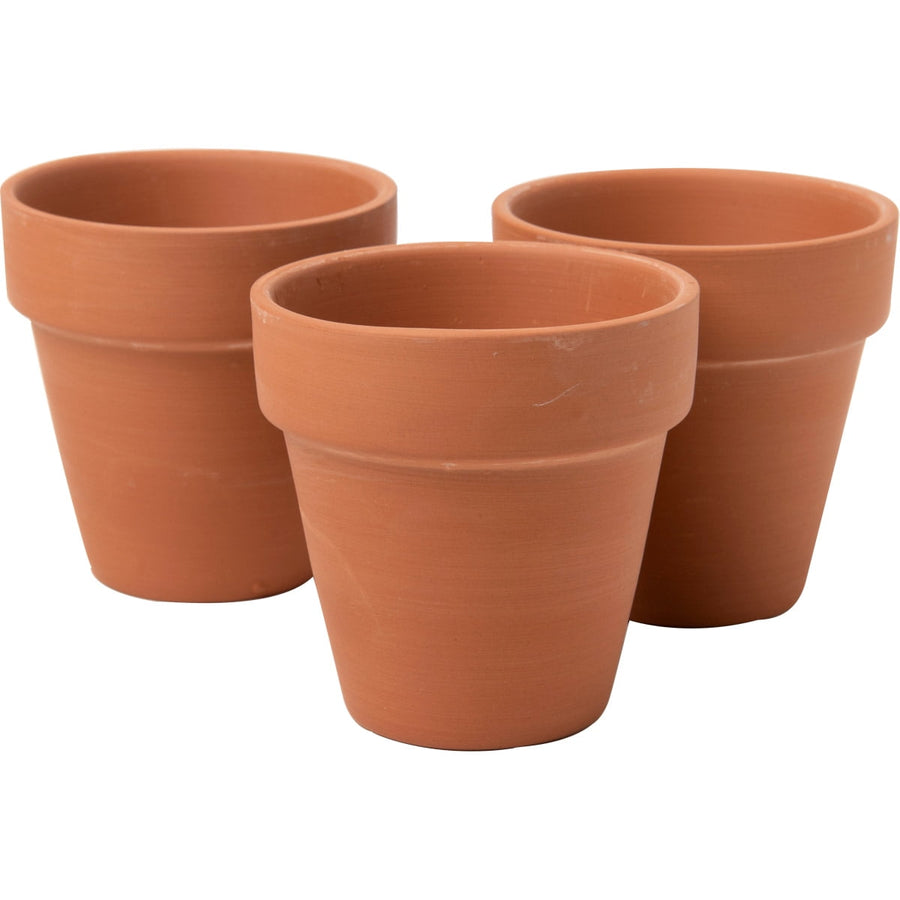 Three unpainted terra cotta flower pots arranged together on a white background