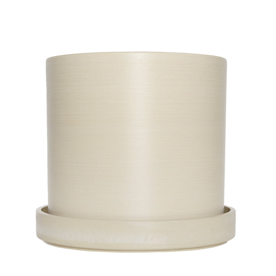 Cream cylindrical upcycled planter with matching saucer on white background, smooth subtle textured finish
