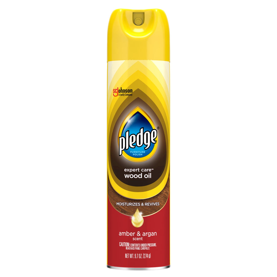 Tall yellow Pledge aerosol can labeled “expert care wood oil” with amber & argan scent on a white background.