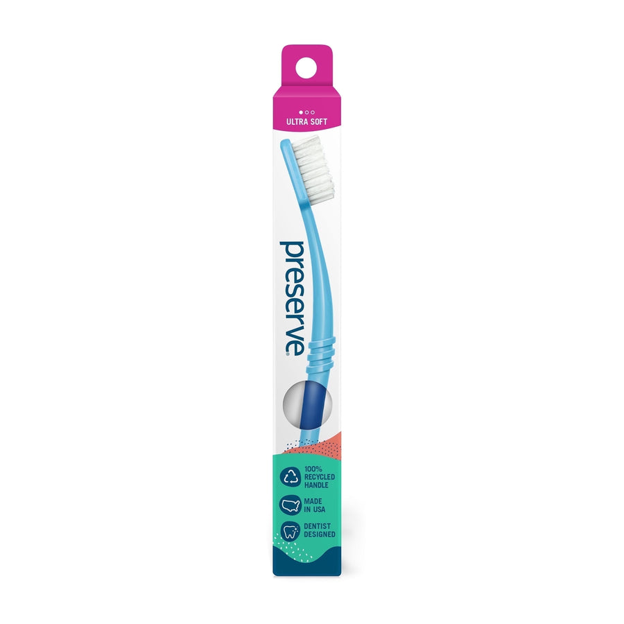 Single Preserve toothbrush in tall white blister-style box with blue curved handle and pink ultra soft header