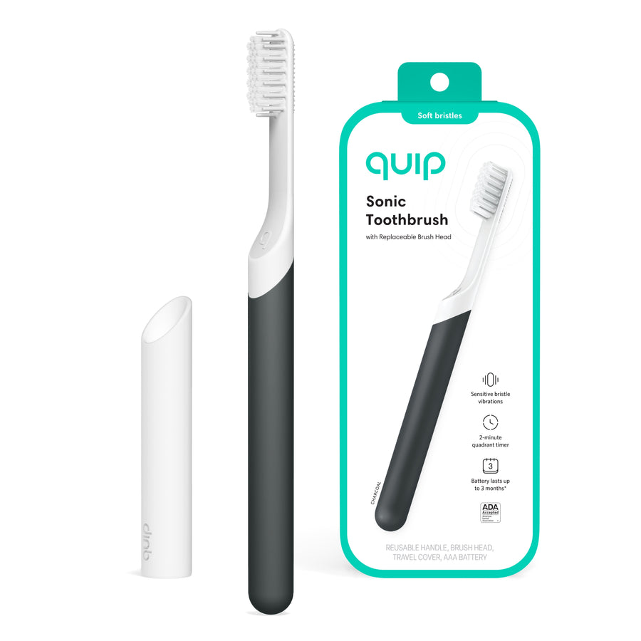 Charcoal Quip sonic toothbrush with white travel cover and retail card showing packaged brush image on white background