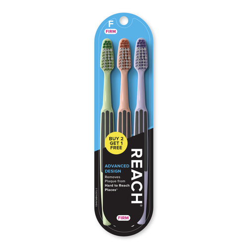 Three REACH toothbrushes in pastel handles packaged on blue blister card with brand logo and promotional sticker