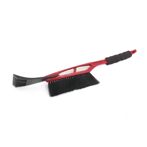 Red plastic car snow brush with black bristles and integrated ice scraper, angled on white background