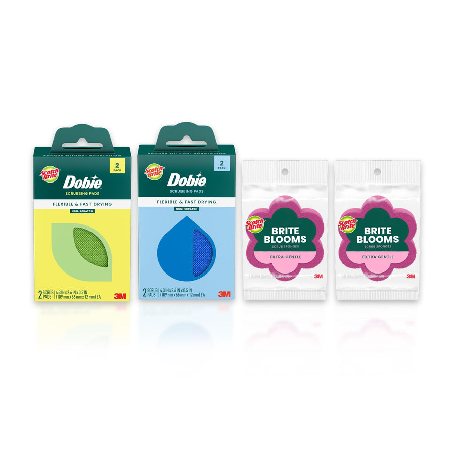 Two Dobie scrub pad boxes and two pink Scotch-Brite Brite Blooms flower-shaped sponges on white