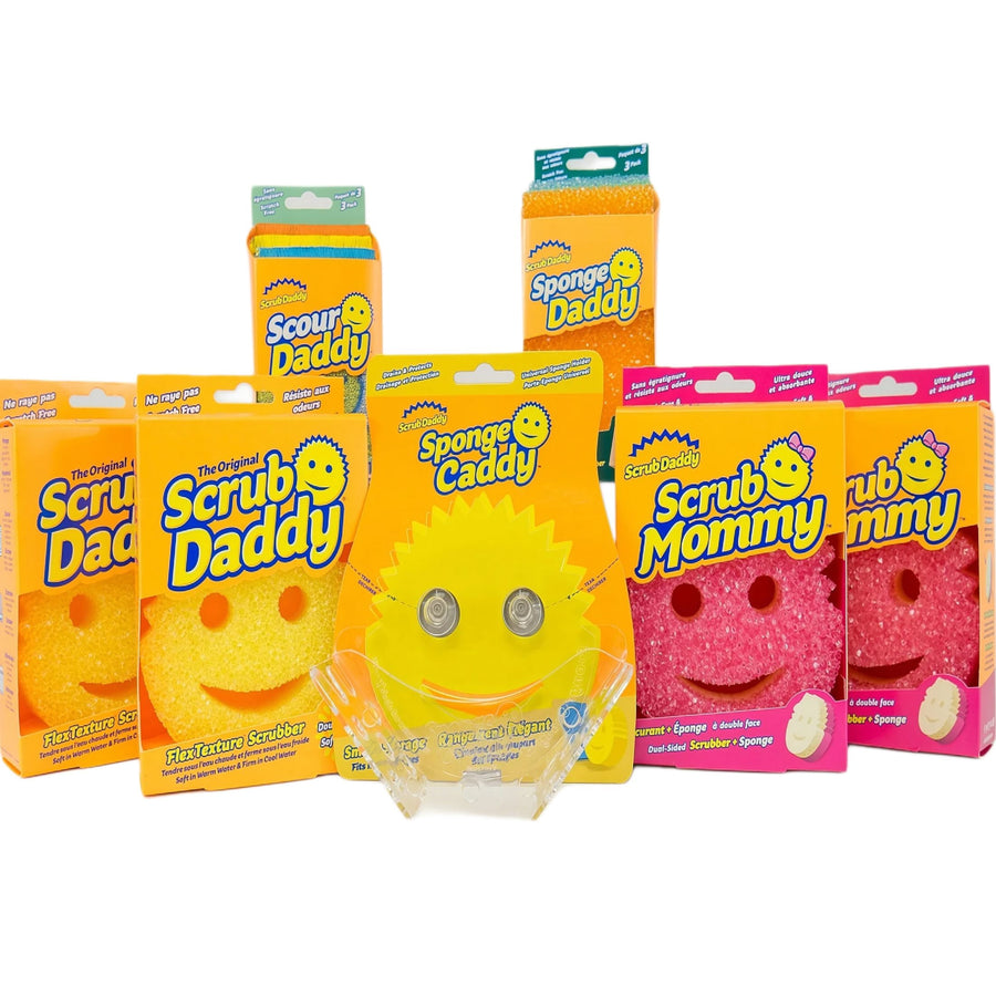 Assortment of Scrub Daddy and Scrub Mommy packaged sponges arranged against white background