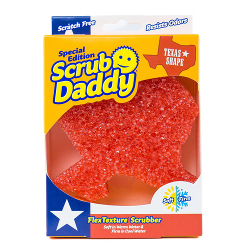 Scrub Daddy special edition Texas-shaped orange non-scratch scrubber visible through yellow retail box