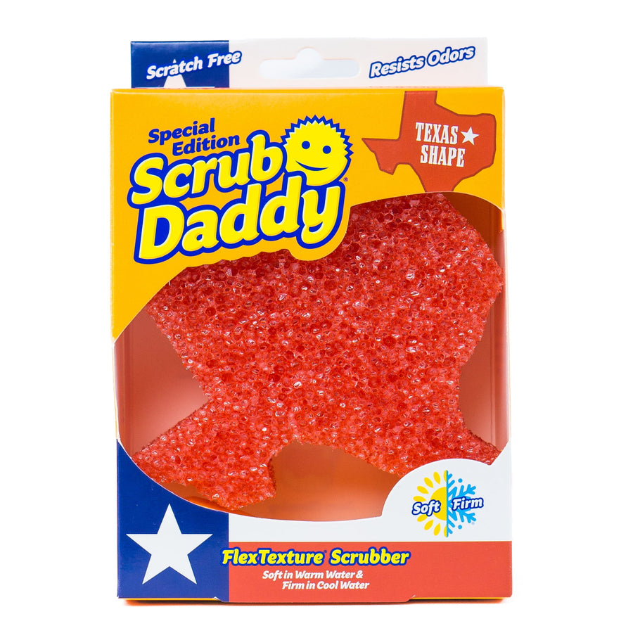 Scrub Daddy special edition Texas-shaped orange non-scratch scrubber visible through yellow retail box