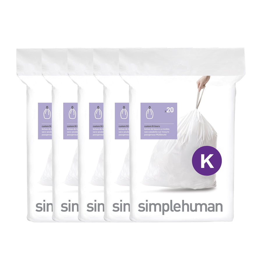 Five stacked white simplehuman dispenser packs showing a tied white trash bag and purple 'K' badge.