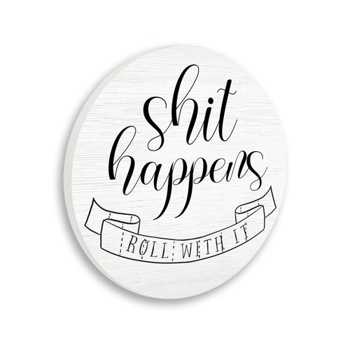 Round white wood-grain wall plaque with black script “shit happens” and a ribbon reading “roll with it” illustration