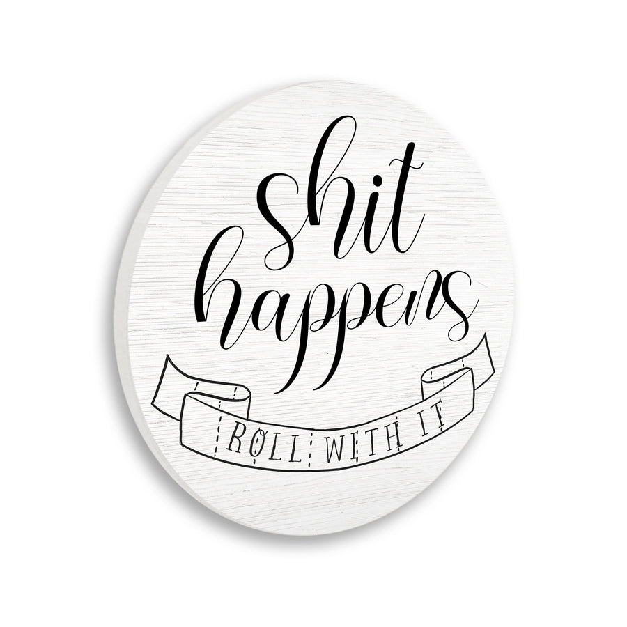Round white wood-grain wall plaque with black script “shit happens” and a ribbon reading “roll with it” illustration