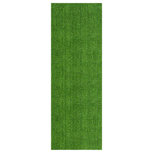 Rectangular strip of bright green artificial grass turf photographed on a white background.
