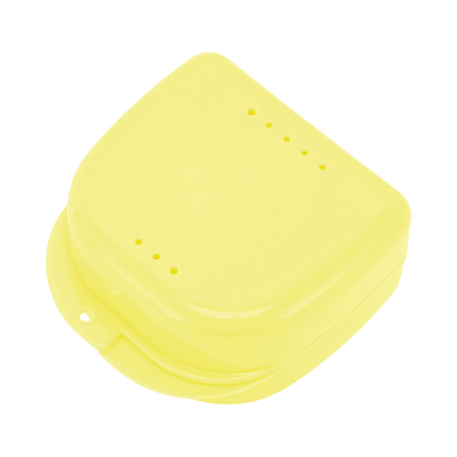 Yellow plastic retainer or braces storage case photographed on a white background, top view with vent holes.