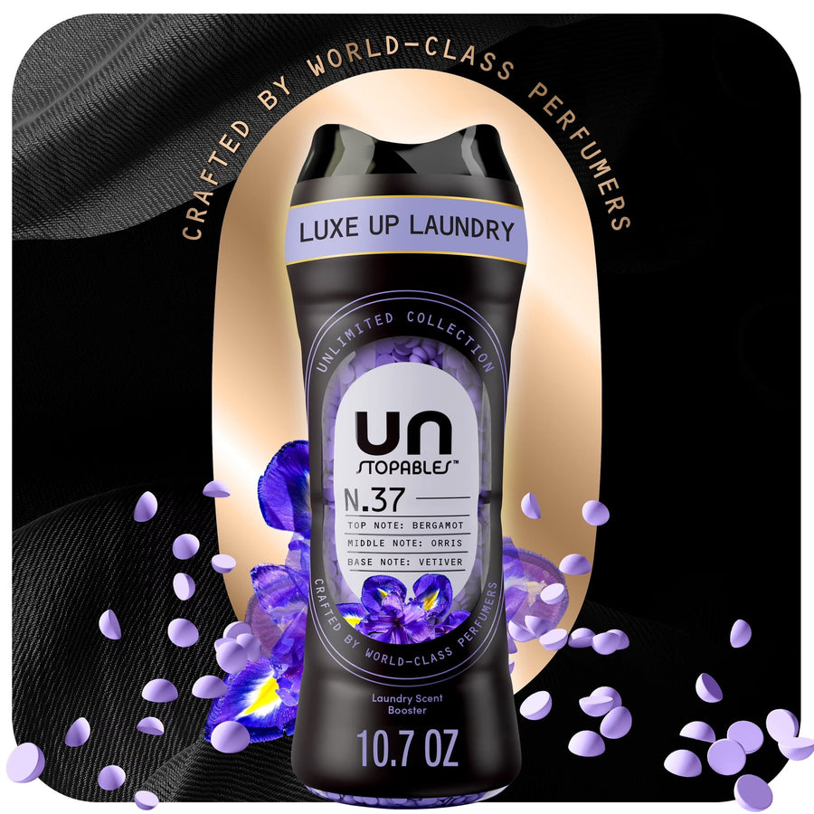 Black Unstopables N.37 scent booster bottle with purple floral accents and scattered scent beads on a dark luxe background.