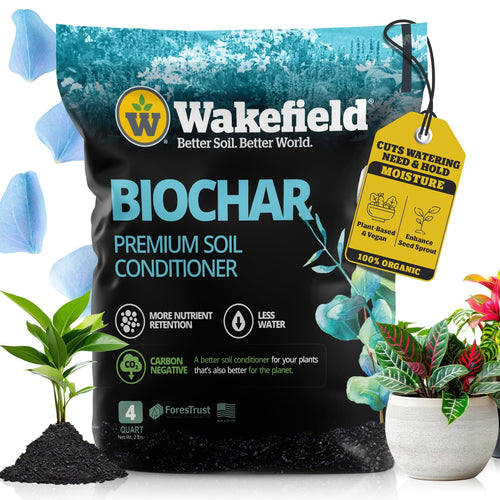 Front-facing Wakefield Biochar premium soil conditioner bag with plant graphics, tag callout, and potted plants beside it.