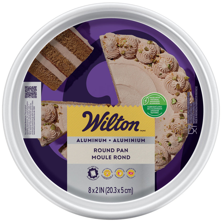 Top-down packaged Wilton aluminum 8-inch round cake pan with product label and cake photo