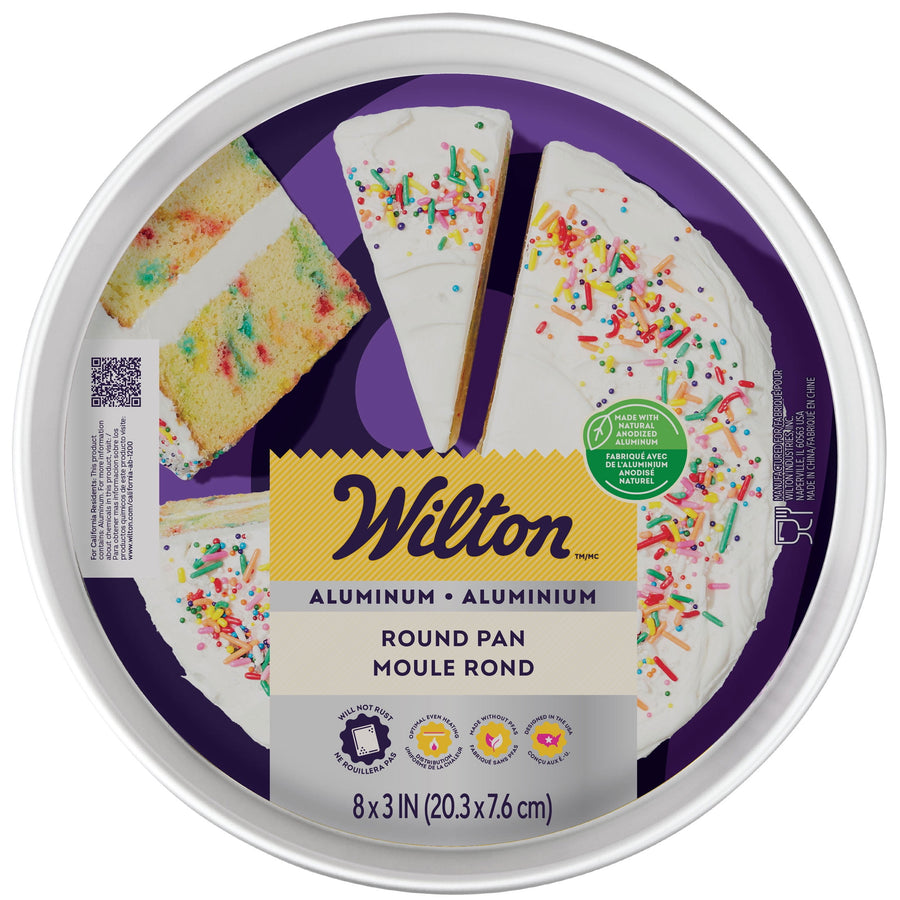 Top-down view of Wilton branded round aluminum cake pan label with sliced frosted cake graphic