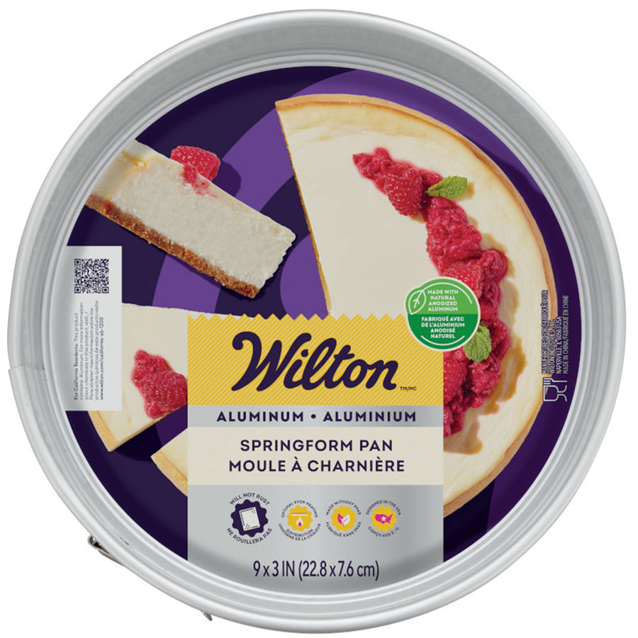 Top-down view of Wilton branded round springform pan packaging showing cheesecake graphic and product label