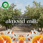Promotional image with almond trees and splash of milk, honeycomb and almonds for almond milk scent