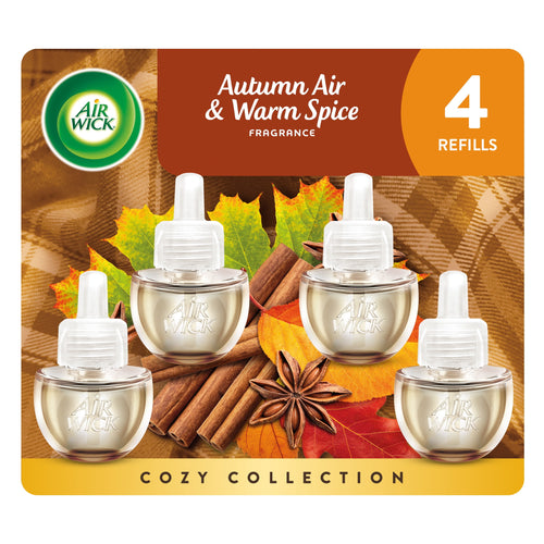 Four Air Wick plug-in oil refill bottles displayed over cinnamon sticks and autumn leaves on warm packaging artwork.