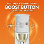 Air Wick plug-in device front view with callout to a 'boost button' and orange swirl background with peach accents