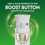 Air Wick plug-in warmer front view with text 'Need a quick refresh? Tap the boost button for instant fragrance' on green art