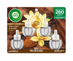 Retail blister-pack photo of four Air Wick plug-in oil refills with vanilla flowers, brown sugar imagery and product text.