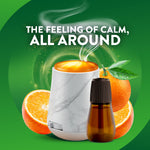 Air Wick marble diffuser and amber fragrance bottle with orange fruit background and text 'The feeling of calm, all around'.
