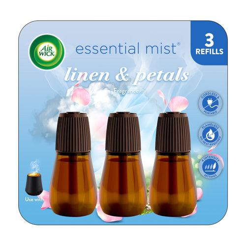 Air Wick Essential Mist Linen & Petals refill trio shown as three amber refill bottles with brown caps on branded blue packaging.