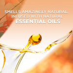 Close-up liquid splash and droplet over a warm background with text about being infused with natural essential oils